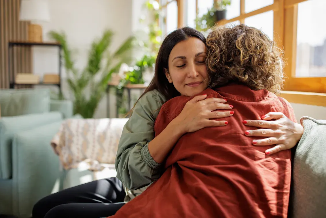 Two women supporting each other in conversation